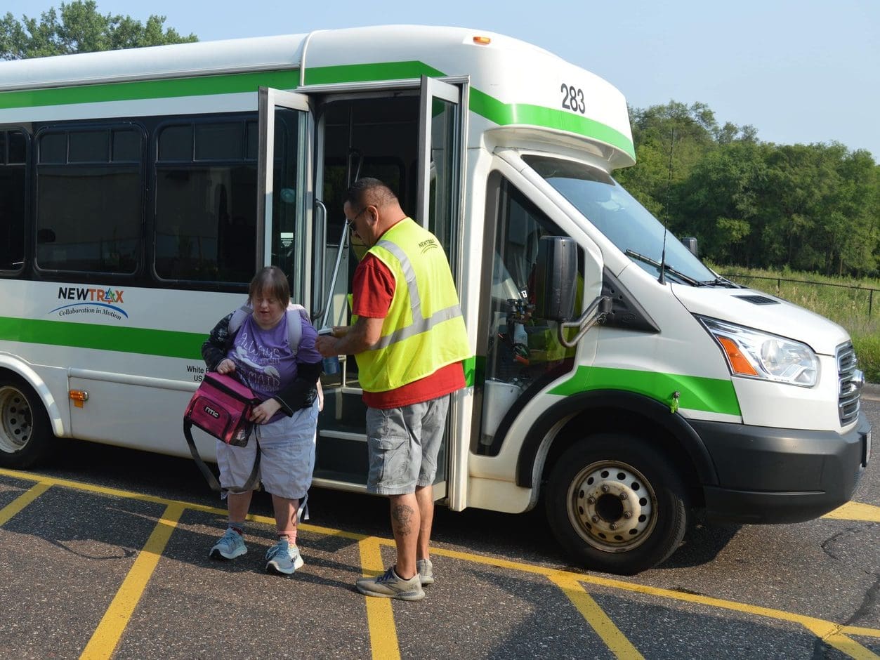 driver helps client exit Newtrax van